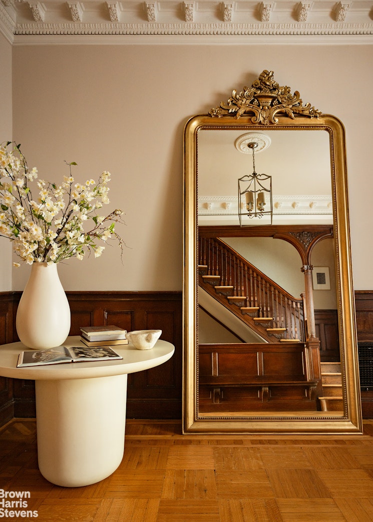 57 East 74th Street Manhattan, NY 10021 - Photo 3 of 60 a view of a living room with a fireplace and a chandelier