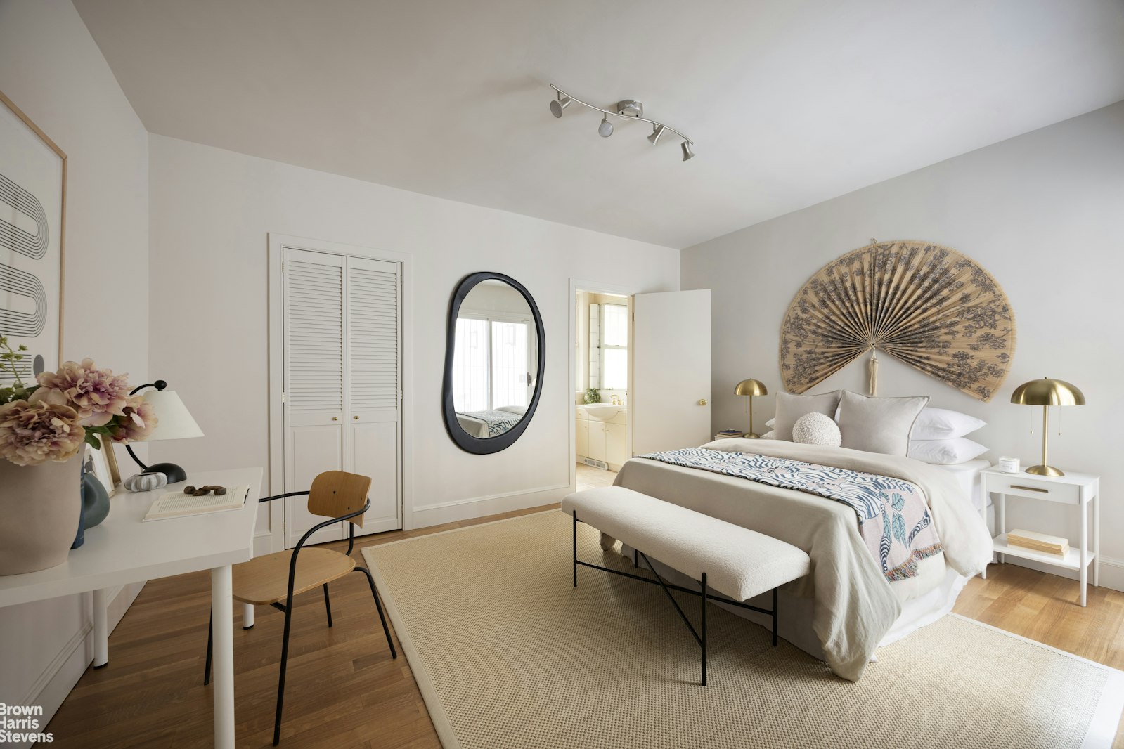 57 East 74th Street Manhattan, NY 10021 - Photo 53 of 60 a spacious bedroom with a bed and a chandelier