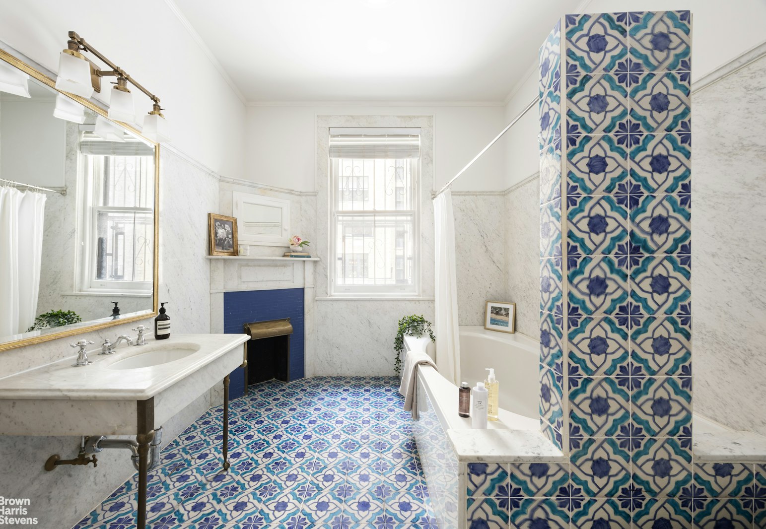 57 East 74th Street Manhattan, NY 10021 - Photo 54 of 60 a spacious bathroom with a sink and mirror