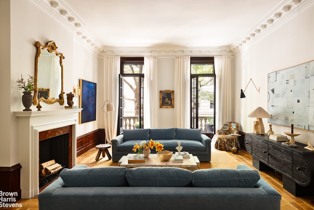 57 East 74th Street Manhattan, NY 10021 - Photo 4 of 60 a living room with furniture fireplace and a large window
