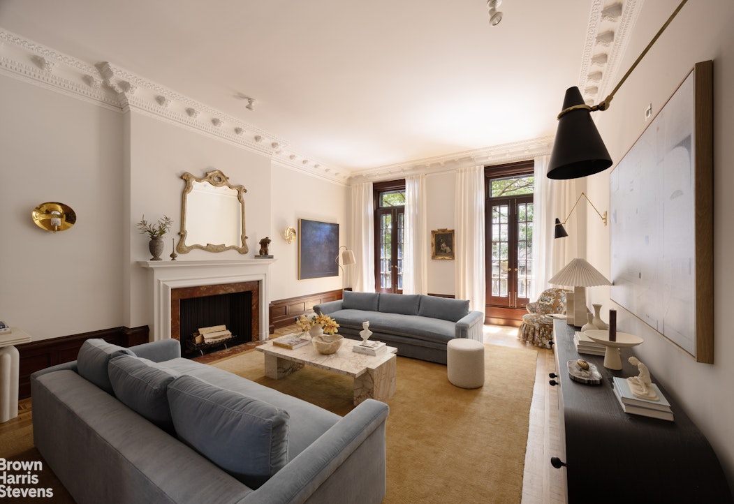 57 East 74th Street Manhattan, NY 10021 - Photo 5 of 60 a living room with furniture and a fireplace