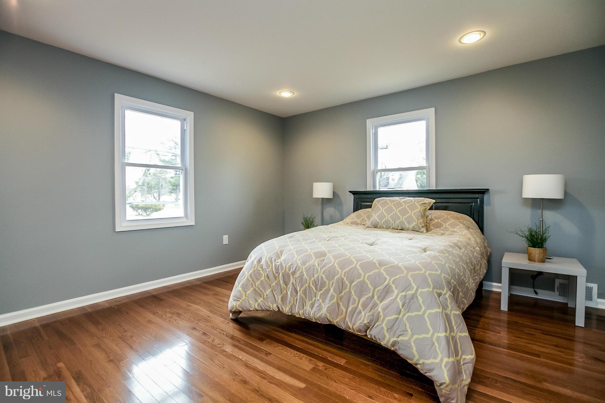 3534 Milford Mill Road Baltimore, MD 21244 - Photo 15 of 30 a bedroom with a bed and wooden floor