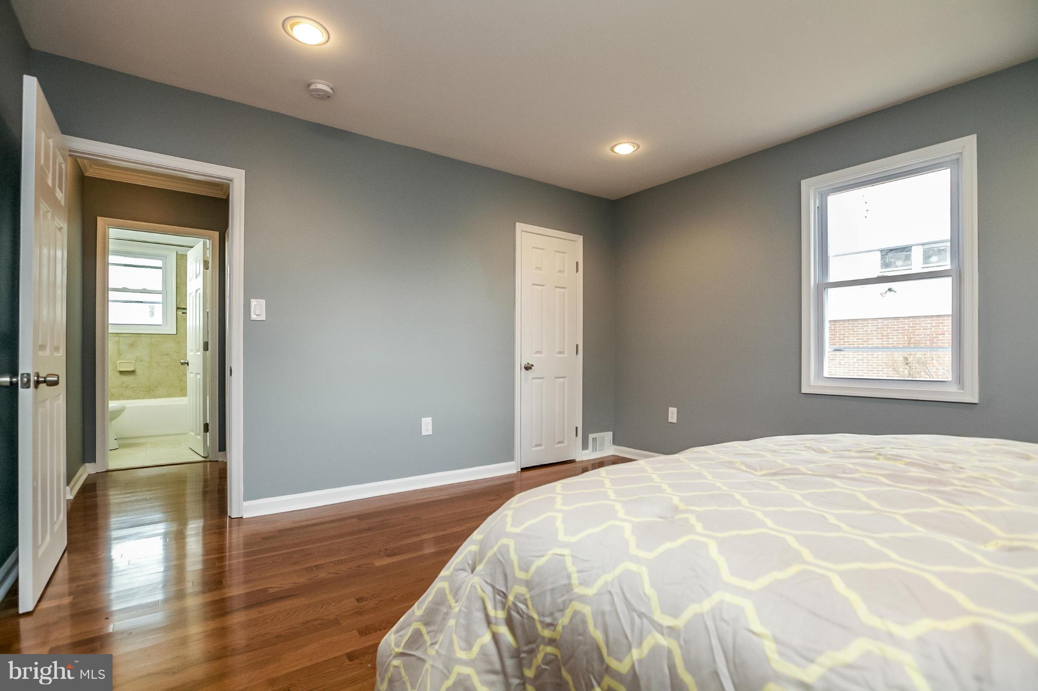 3534 Milford Mill Road Baltimore, MD 21244 - Photo 16 of 30 a spacious bedroom with a bed and wooden floor