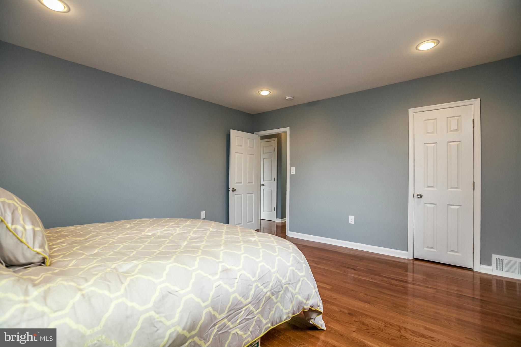 3534 Milford Mill Road Baltimore, MD 21244 - Photo 17 of 30 a bedroom with a large bed and wooden floor