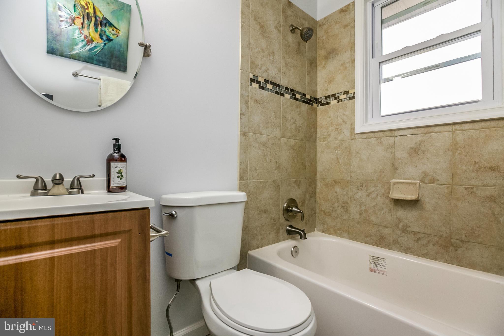3534 Milford Mill Road Baltimore, MD 21244 - Photo 18 of 30 a bathroom with a sink a toilet and a bathtub