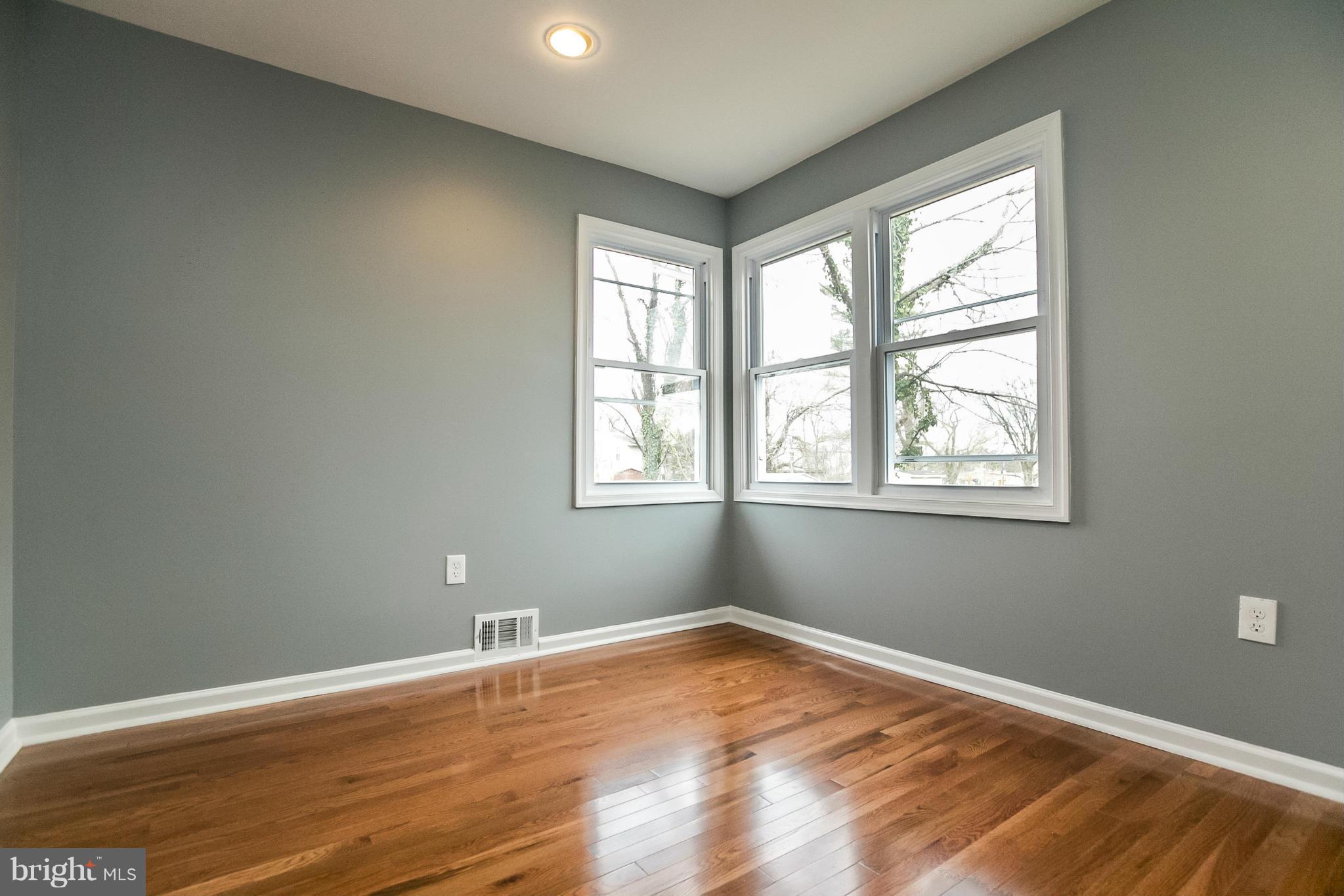 3534 Milford Mill Road Baltimore, MD 21244 - Photo 19 of 30 a view of empty room with wooden floor and fan