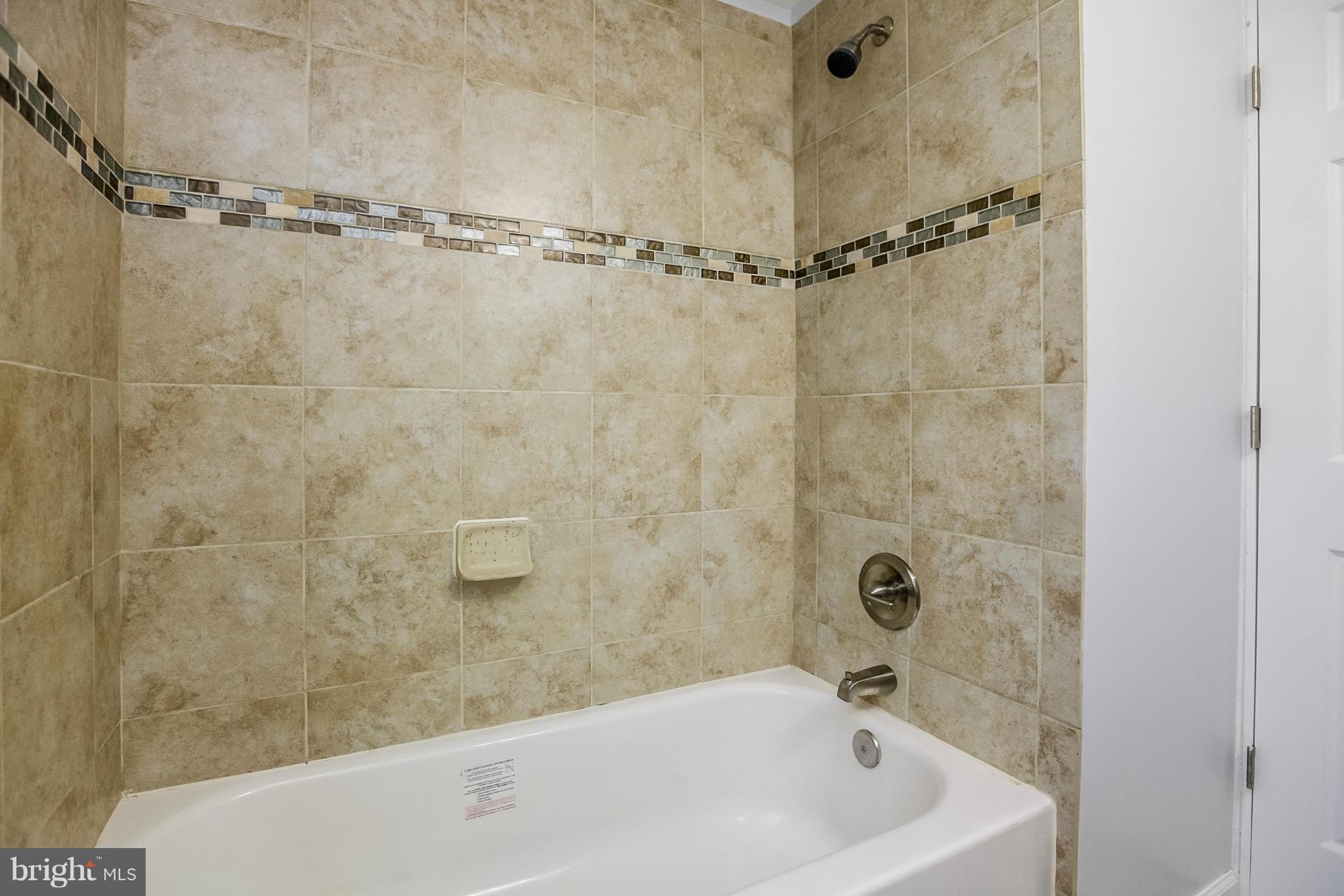 3534 Milford Mill Road Baltimore, MD 21244 - Photo 10 of 30 a bathroom with a bathtub and a shower