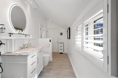 a bathroom with a double vanity sink and a mirror