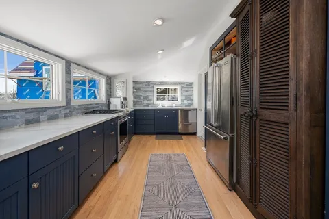 a kitchen with stainless steel appliances a refrigerator and a sink