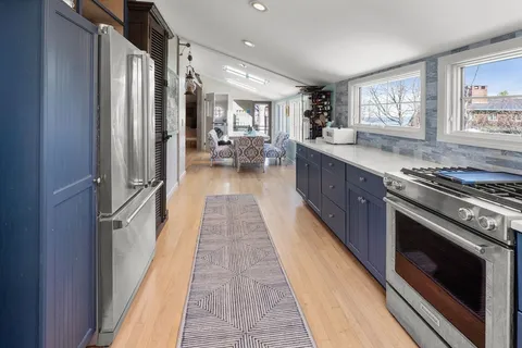 a kitchen with stainless steel appliances granite countertop a stove a sink and a refrigerator