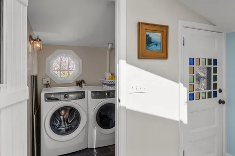 a view of a hallway with washer and dryer