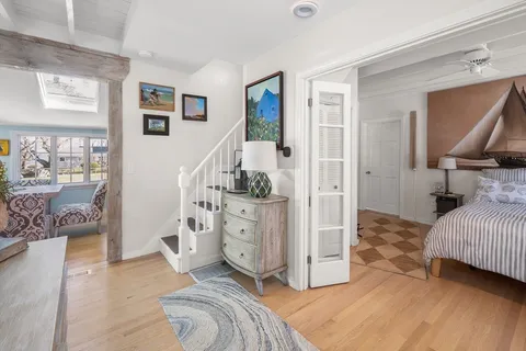 a view of a bedroom with bed and wooden floor