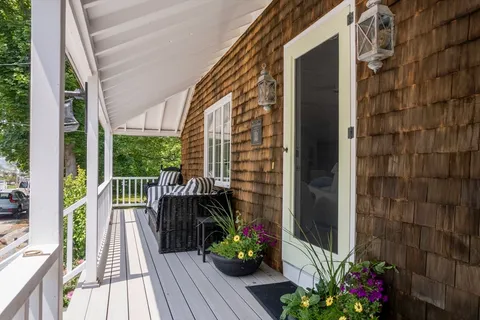 a view of a balcony with wooden floor