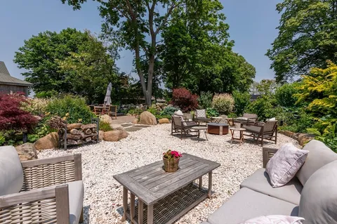 an outdoor space with furniture and garden