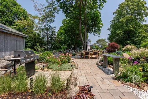 a view of a backyard with sitting area