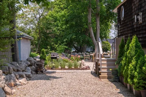 a couple of potted plants in front of a house