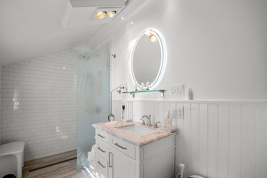 19 Old Garden Road Rockport, MA 01966 - Photo 8 of 42 a bathroom with a granite countertop sink a mirror and a toilet