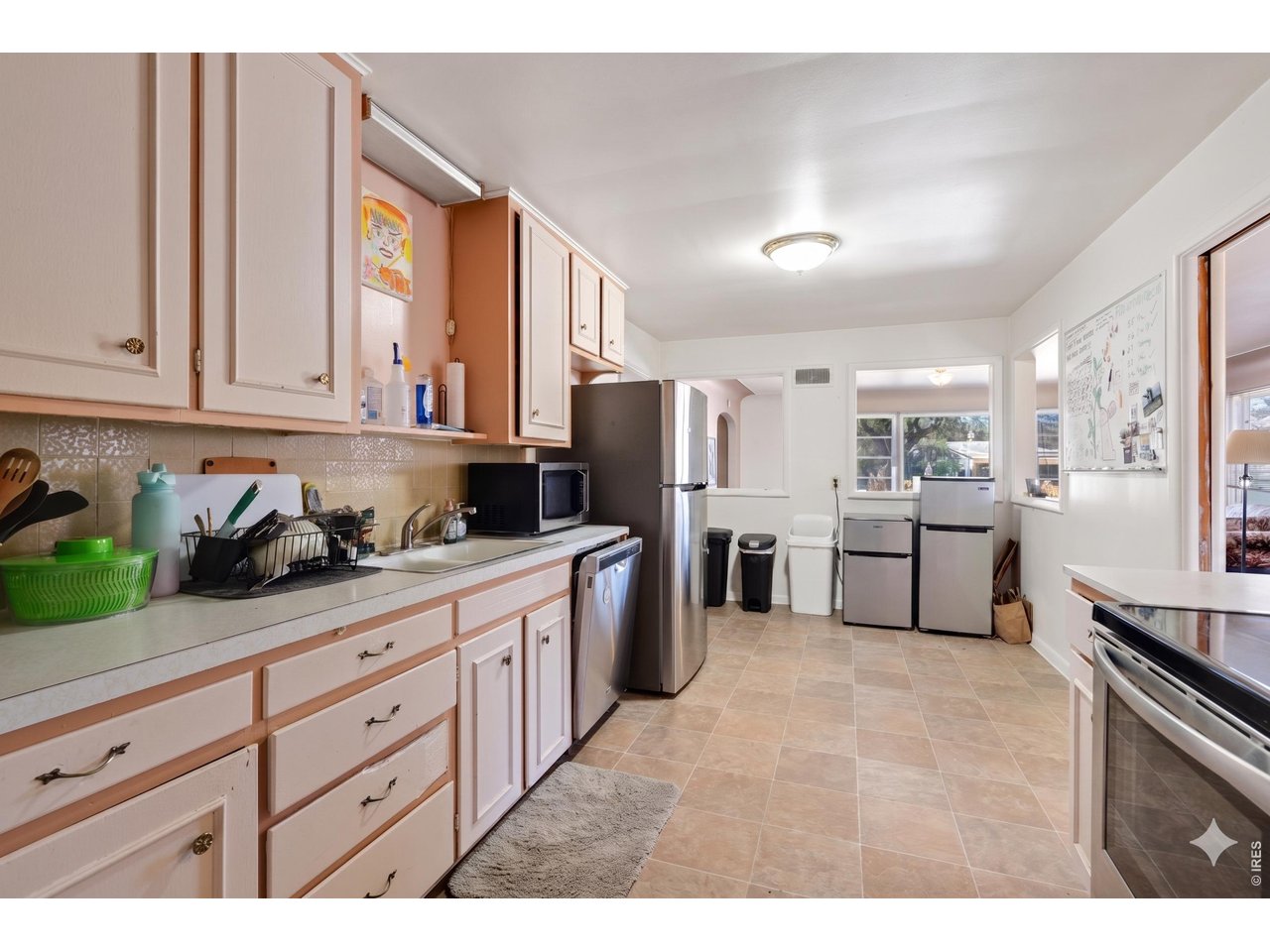 821 West Mulberry Street Fort Collins, CO 80521 - Photo 6 of 13 a kitchen with stainless steel appliances granite countertop a refrigerator sink and cabinets
