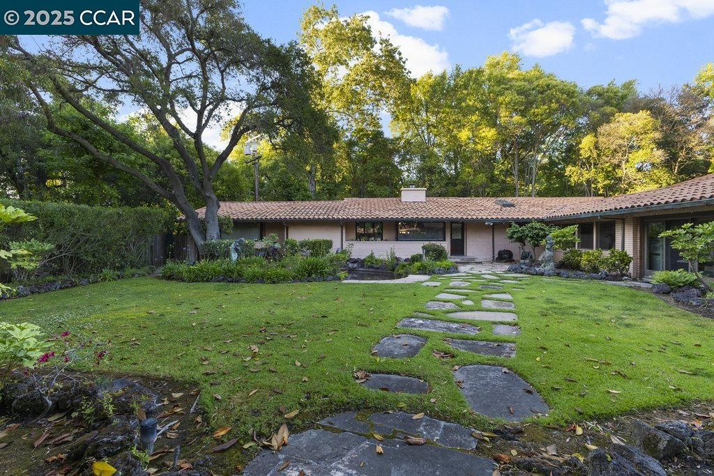 940 Reliez Station Lane Lafayette, CA 94549 - Photo 28 of 53 a front view of a house with a yard table and chairs