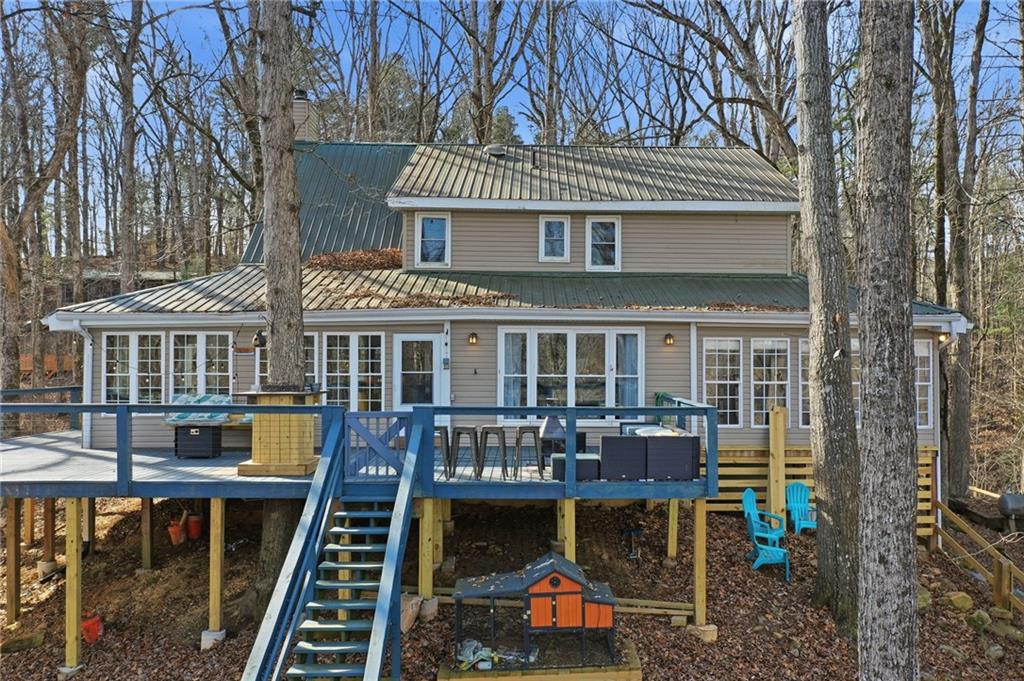 1008 River Estates Road Cleveland, GA 30528 - Photo 2 of 37 a front view of a house with swimming pool table and chairs