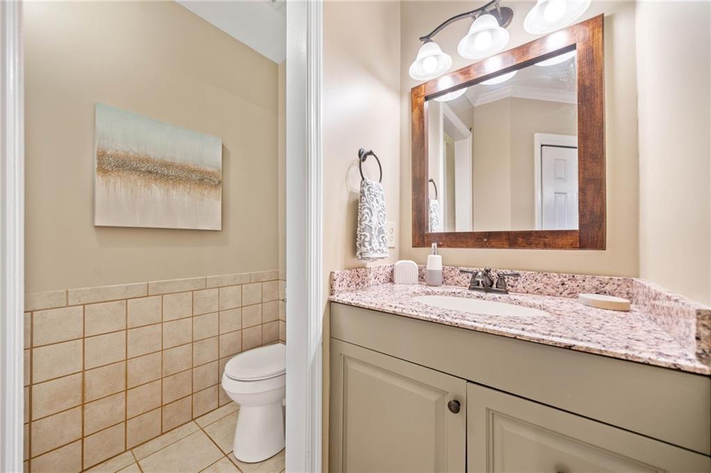 1008 River Estates Road Cleveland, GA 30528 - Photo 23 of 37 a bathroom with a granite countertop toilet sink and mirror