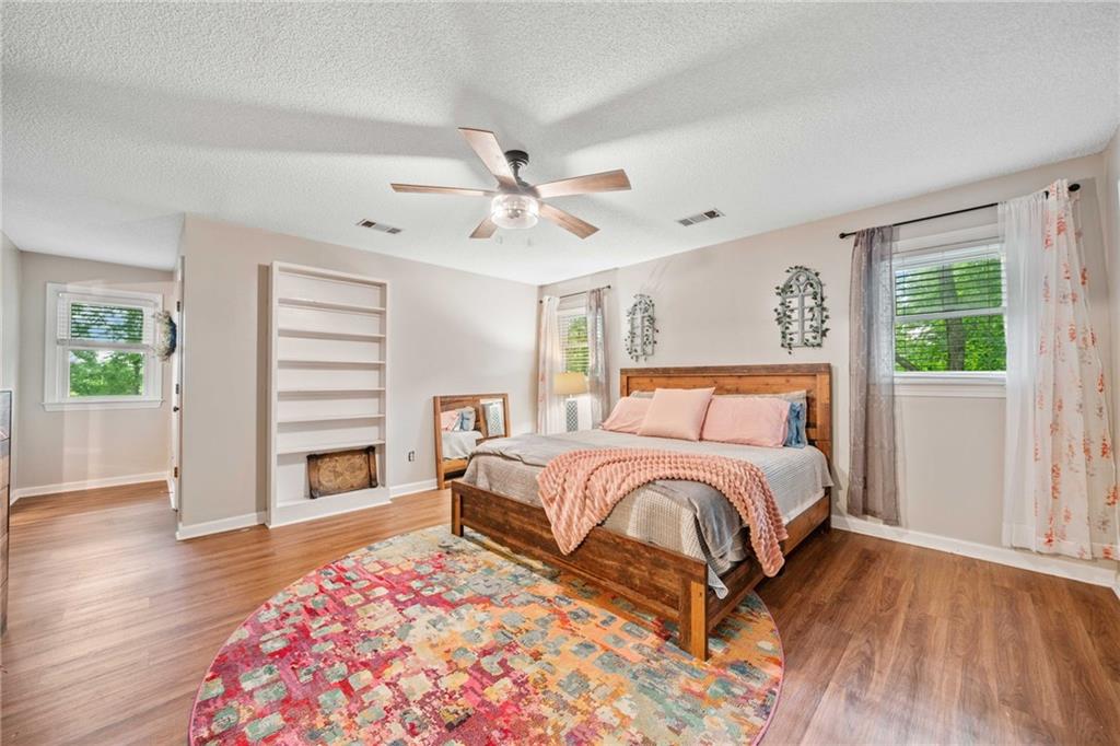 1008 River Estates Road Cleveland, GA 30528 - Photo 25 of 37 a bedroom with a bed chandelier and a window
