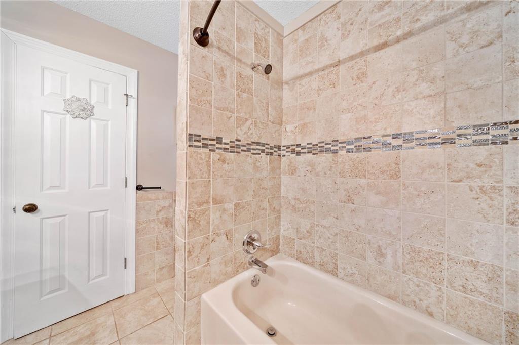 1008 River Estates Road Cleveland, GA 30528 - Photo 28 of 37 a bathroom with a bathtub and shower