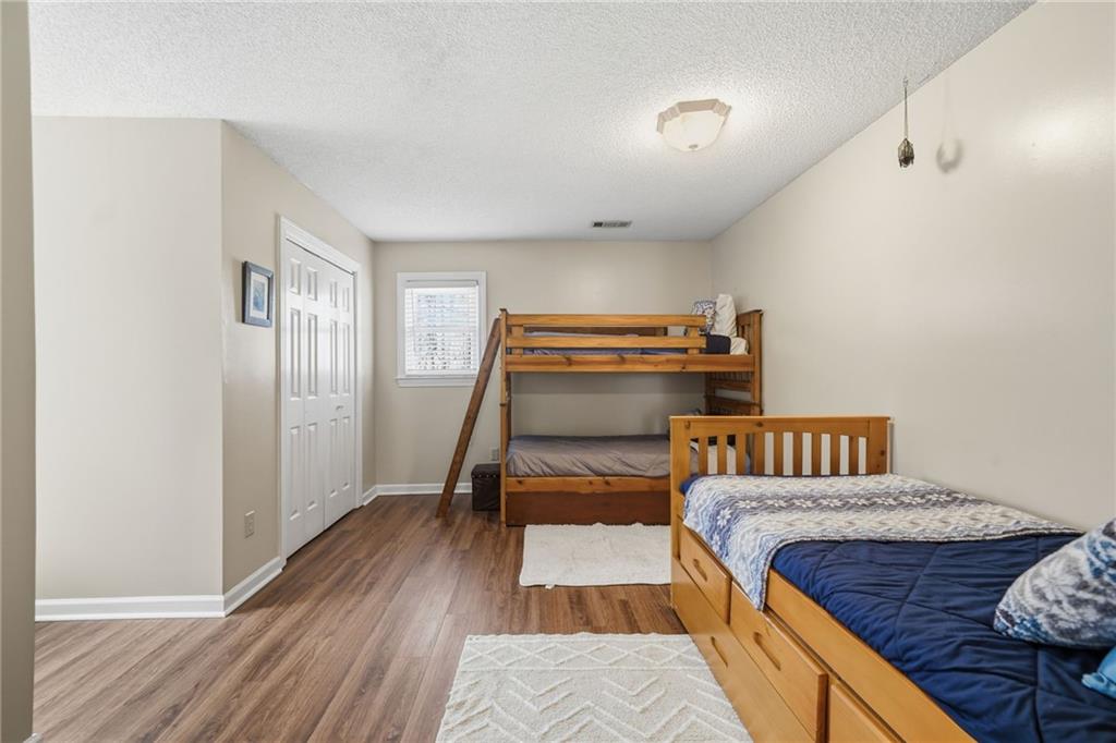 1008 River Estates Road Cleveland, GA 30528 - Photo 30 of 37 a bedroom with a bed and wooden floor
