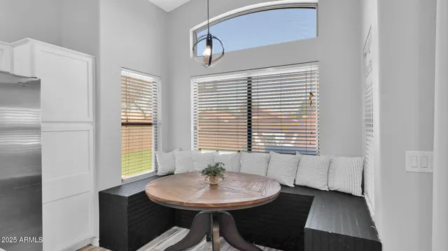a view of a dining room with furniture and window