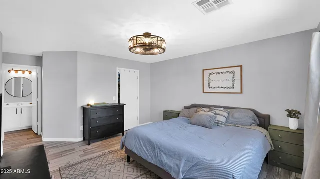 a bedroom with a bed and a mirror