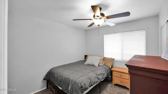 a bedroom with a bed and a table in it