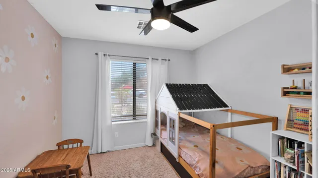 a bedroom with a bed and a ceiling fan