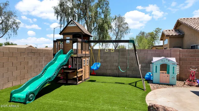 a bedroom with a table and chairs