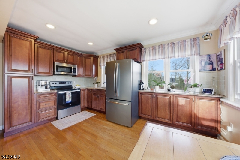 7 Valley Road Randolph, NJ 07869 - Photo 7 of 47 a kitchen with stainless steel appliances granite countertop a refrigerator a stove top oven a sink and dishwasher