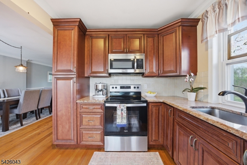 7 Valley Road Randolph, NJ 07869 - Photo 9 of 47 a kitchen with stainless steel appliances granite countertop a stove a sink and a microwave