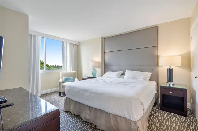 a bedroom with a bed and a table