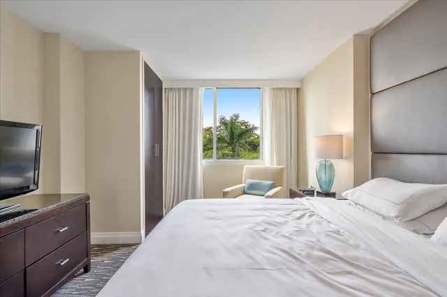 a bedroom with a bed and a flat screen tv