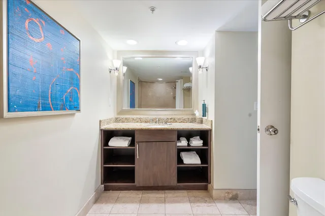 a view of kitchen with stainless steel appliances cabinets and furniture