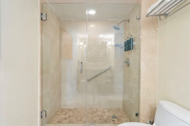 a bathroom with a shower and a glass door
