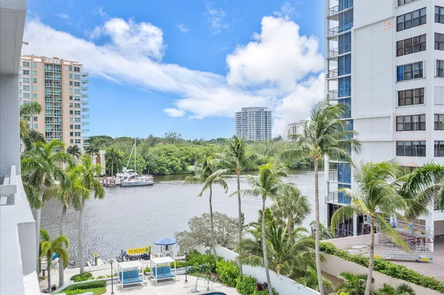 a view of a patio with dining table and chairs potted plants