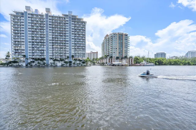 a patio with a table and chairs and potted plants