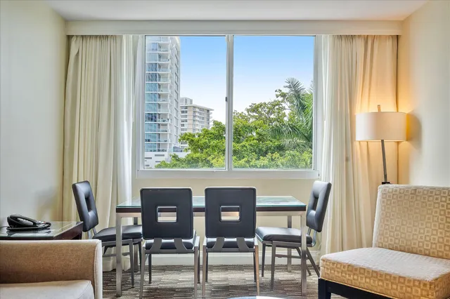 a view of a dining room with furniture and window