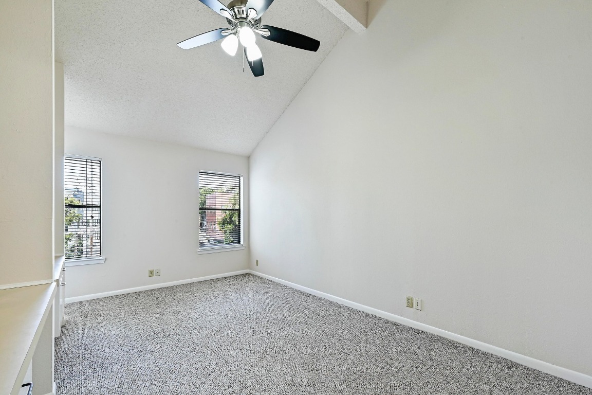 505 Bellevue Place, Unit 7 Austin, TX 78705 - Photo 15 of 24 an empty room with windows and fan