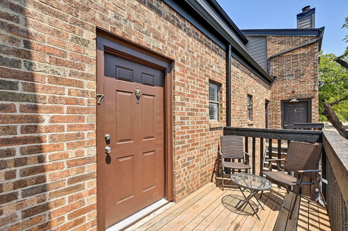 505 Bellevue Place, Unit 7 Austin, TX 78705 - Photo 2 of 24 a view of a balcony with wooden floor