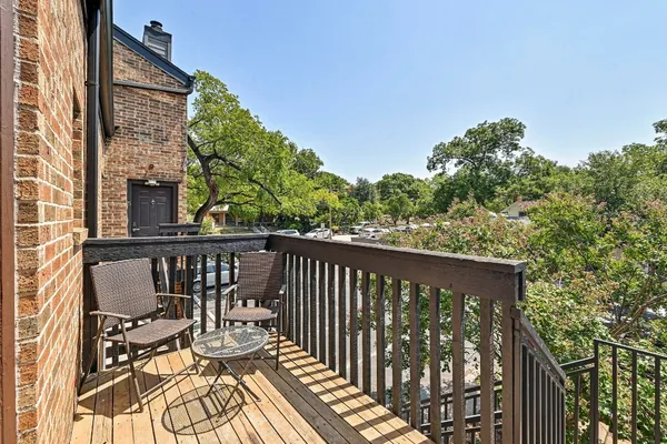 a view of balcony with wooden floor and seating space