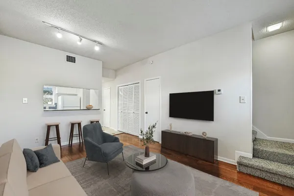 a living room with furniture and a flat screen tv
