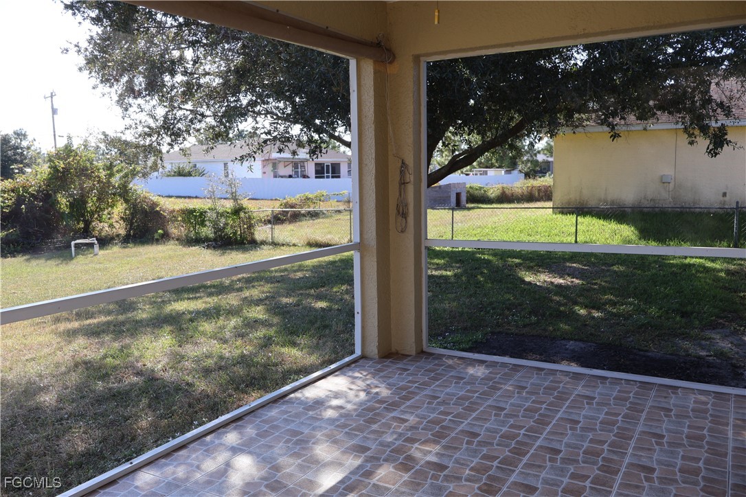 3805 22nd Street Southwest Lehigh Acres, FL 33976 - Photo 23 of 26 a view of a glass door and a yard