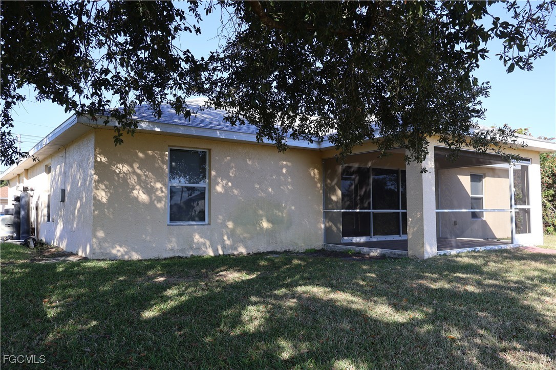 3805 22nd Street Southwest Lehigh Acres, FL 33976 - Photo 6 of 26 a front view of house with yard and trees around