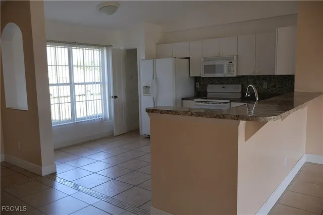 a small space with wooden floor and a window