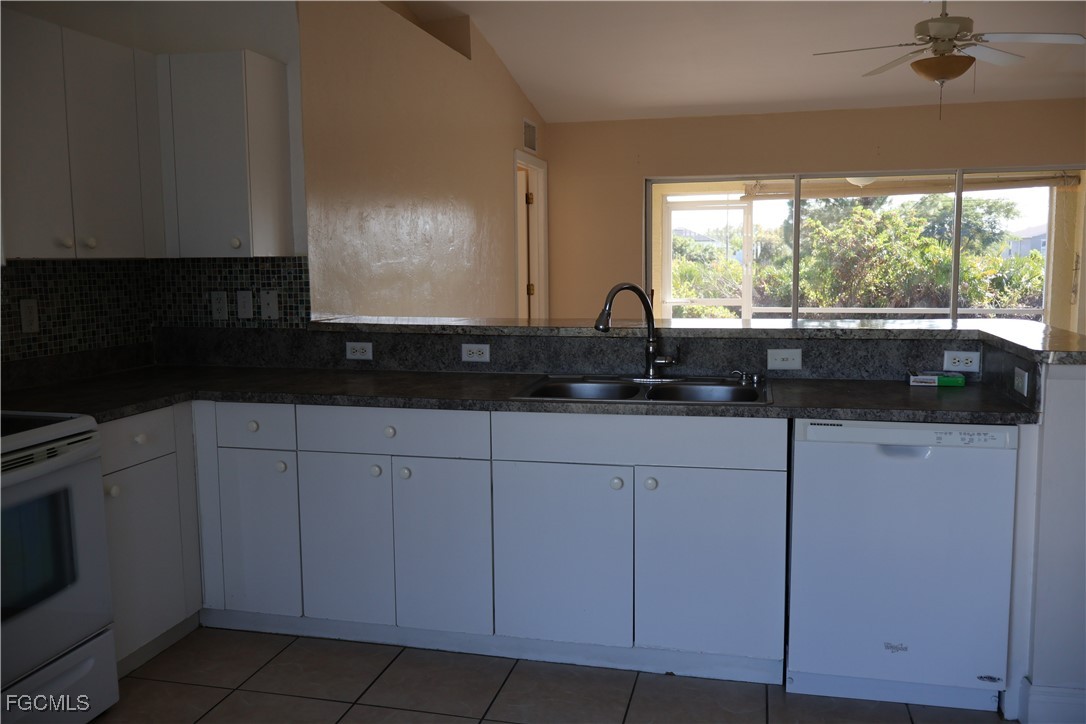 3805 22nd Street Southwest Lehigh Acres, FL 33976 - Photo 10 of 26 a kitchen with a sink and cabinets